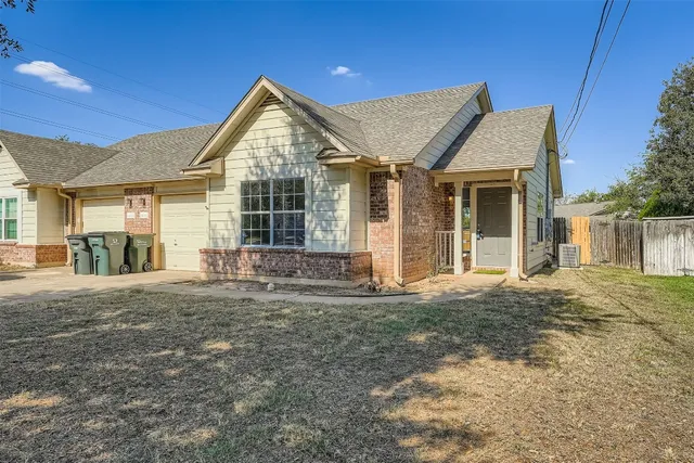 a front view of a house with a garden and yard