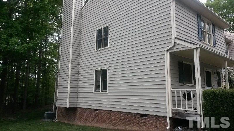 6621 English Ivy Lane Raleigh, NC 27615 - Photo 2 of 17 a view of a house with a yard and garage