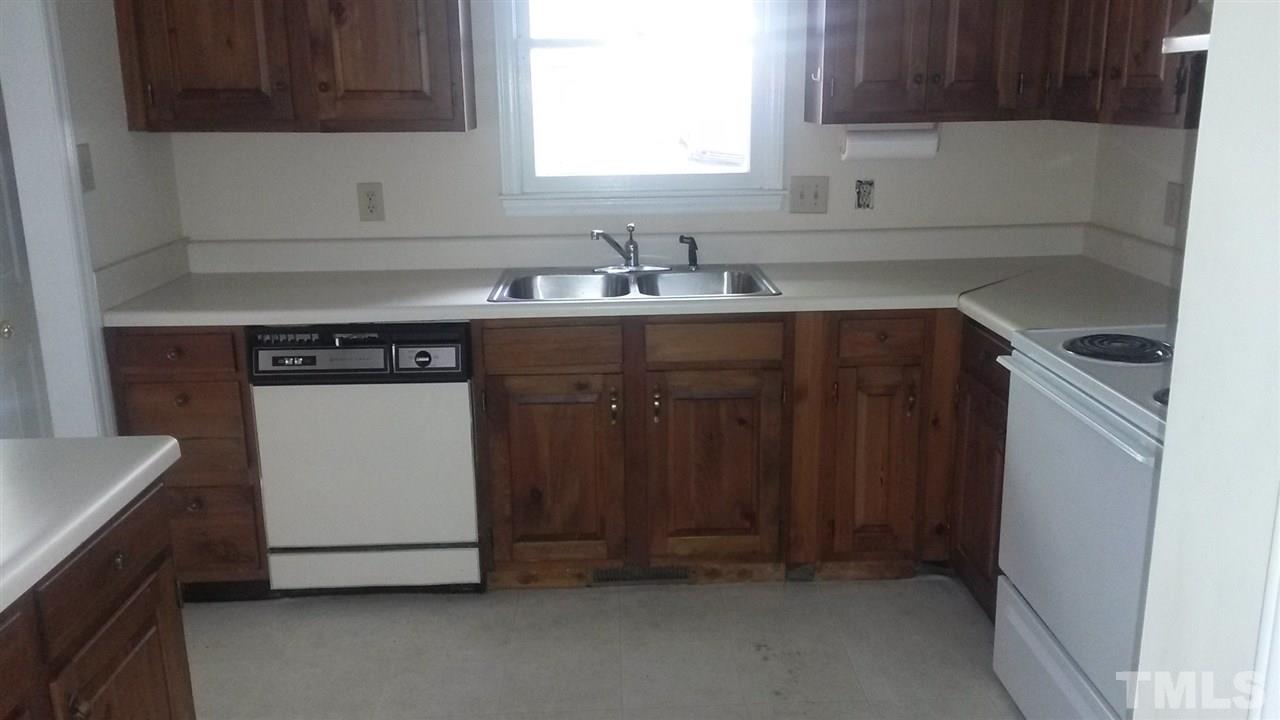 6621 English Ivy Lane Raleigh, NC 27615 - Photo 11 of 17 a kitchen with granite countertop a sink and a stove