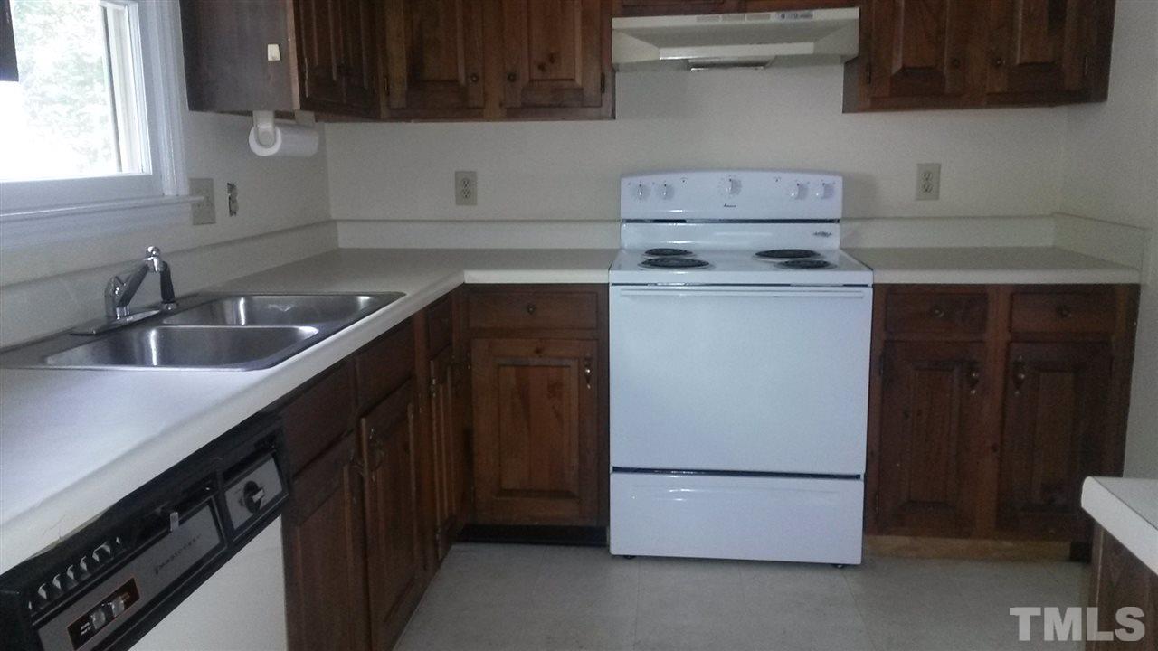 6621 English Ivy Lane Raleigh, NC 27615 - Photo 12 of 17 a kitchen with a sink and a stove top oven