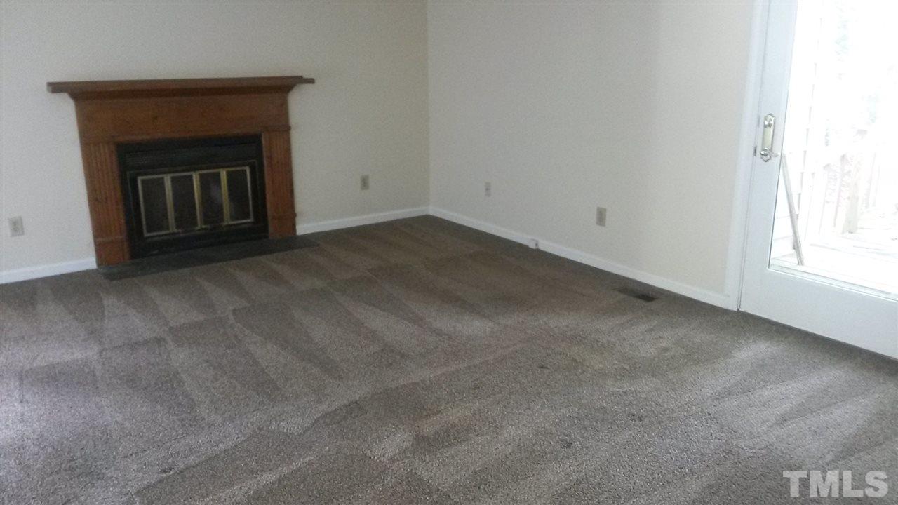 6621 English Ivy Lane Raleigh, NC 27615 - Photo 14 of 17 a view of an empty room with a fireplace