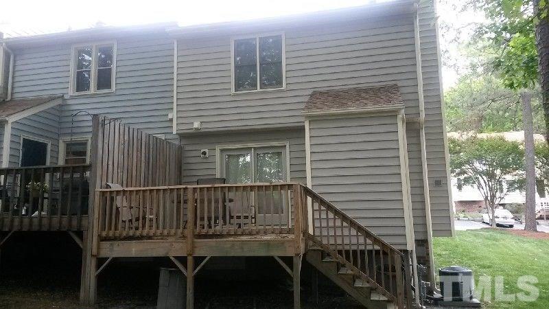 6621 English Ivy Lane Raleigh, NC 27615 - Photo 15 of 17 a view of a deck with two chair and a large window