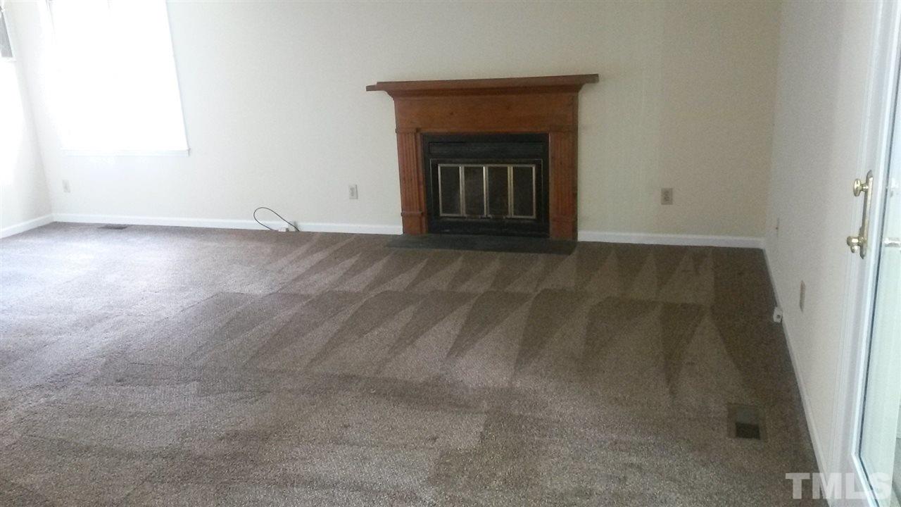 6621 English Ivy Lane Raleigh, NC 27615 - Photo 16 of 17 a view of an empty room with wooden floor and a window