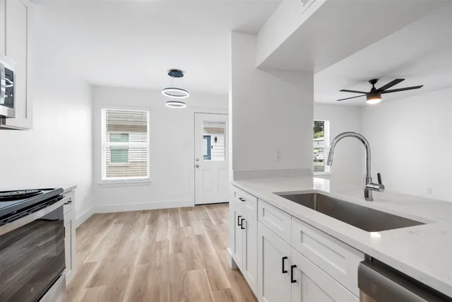 a kitchen with a sink and a stove top oven