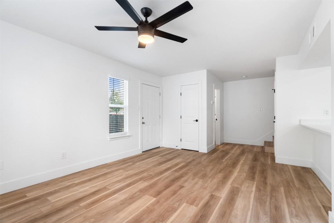1901 Hearthstone Drive, Unit D Austin, TX 78757 - Photo 18 of 30 a view of empty room with wooden floor and fan