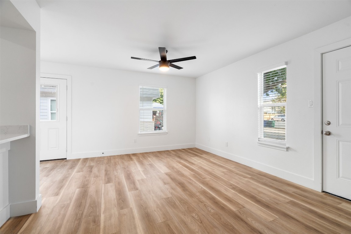 1901 Hearthstone Drive, Unit D Austin, TX 78757 - Photo 19 of 30 wooden floor in an empty room with a window