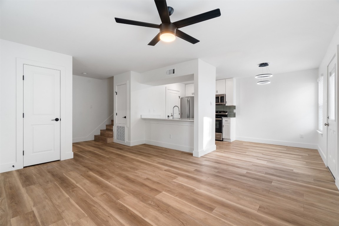 1901 Hearthstone Drive, Unit D Austin, TX 78757 - Photo 20 of 30 a view of a kitchen with a refrigerator and a stove top oven