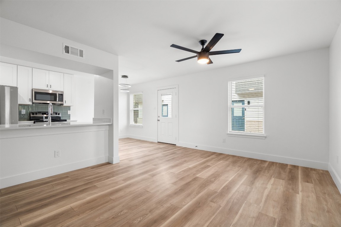 1901 Hearthstone Drive, Unit D Austin, TX 78757 - Photo 21 of 30 a view of a kitchen with microwave and cabinets