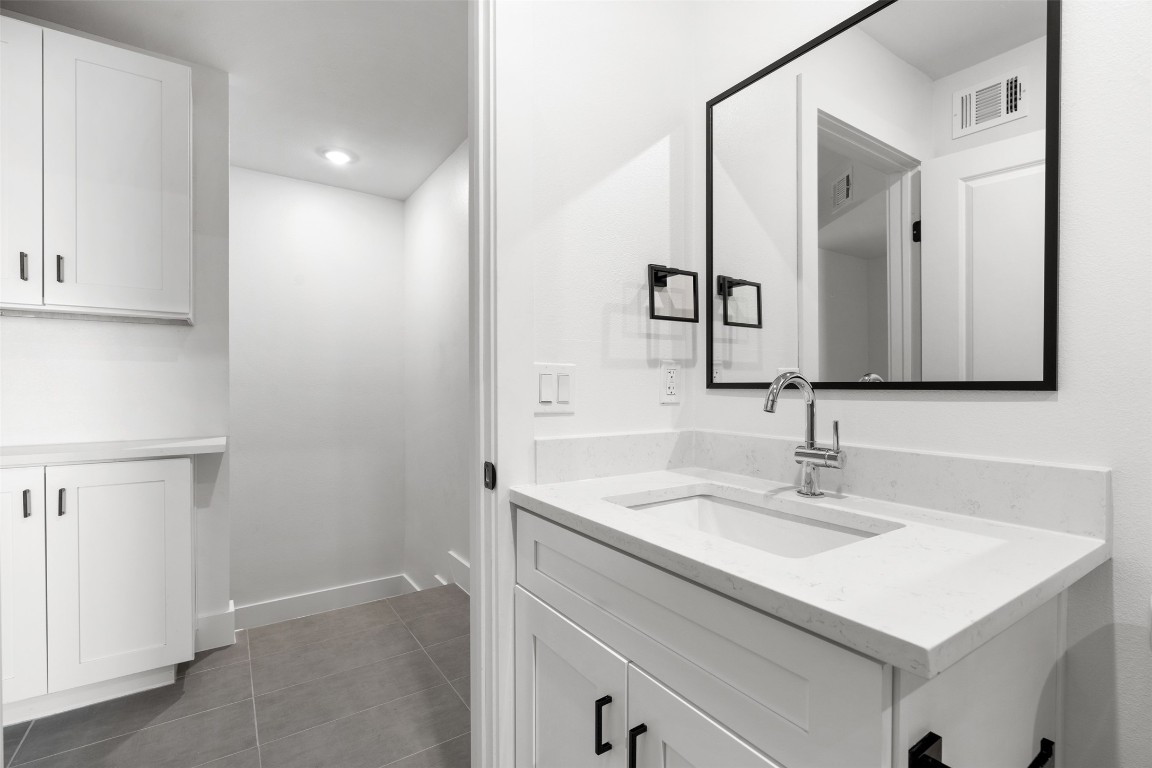 1901 Hearthstone Drive, Unit D Austin, TX 78757 - Photo 28 of 30 a bathroom with a sink and a mirror
