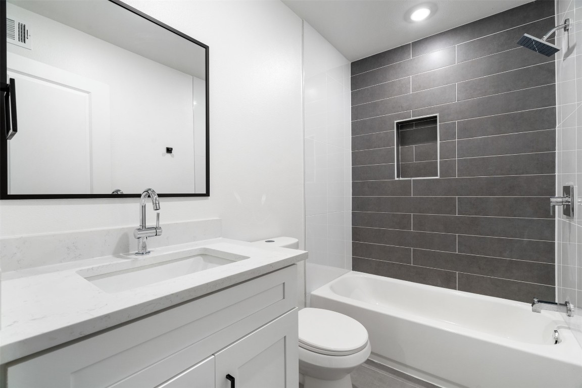 1901 Hearthstone Drive, Unit D Austin, TX 78757 - Photo 29 of 30 a bathroom with a sink a toilet and shower
