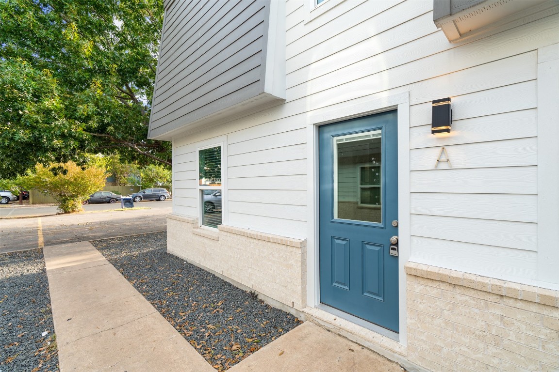 1901 Hearthstone Drive, Unit D Austin, TX 78757 - Photo 6 of 30 a view of a house with a door and wooden walls