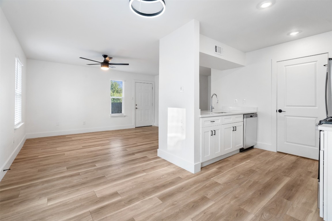 1901 Hearthstone Drive, Unit D Austin, TX 78757 - Photo 7 of 30 a view of a kitchen with wooden floor and a sink