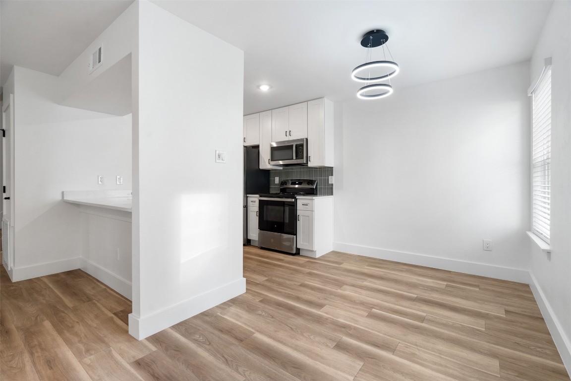 1901 Hearthstone Drive, Unit D Austin, TX 78757 - Photo 8 of 30 a view of kitchen with wooden floor