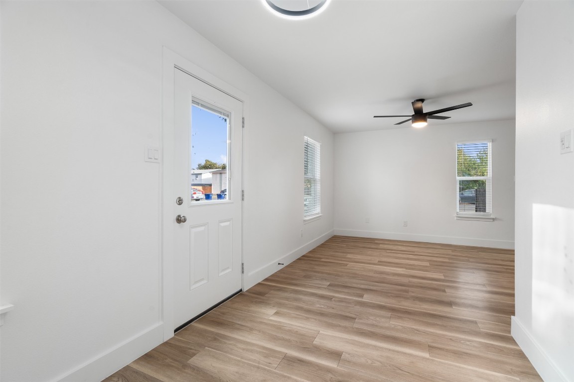 1901 Hearthstone Drive, Unit D Austin, TX 78757 - Photo 10 of 30 wooden floor in an empty room with a window