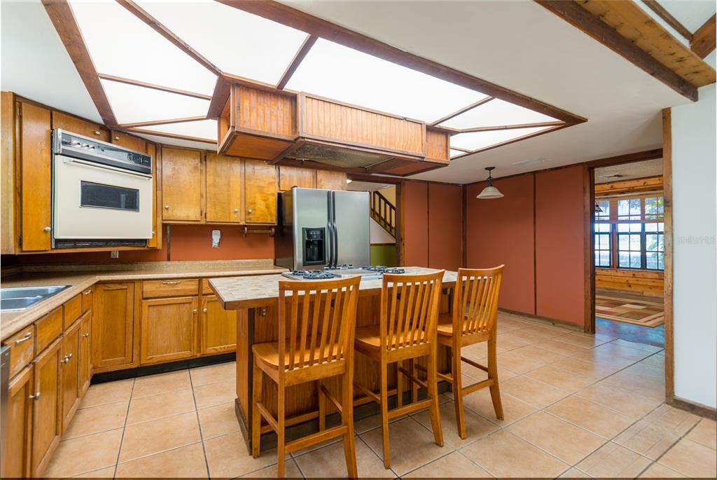 2641 McIntosh Road Dover, FL 33527 - Photo 11 of 58 a dining room with stainless steel appliances granite countertop a sink and a refrigerator