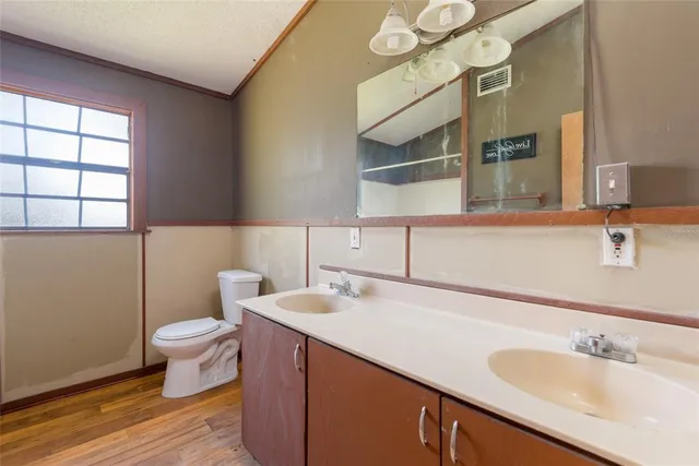 a view of a swimming pool with lawn chairs under an umbrella