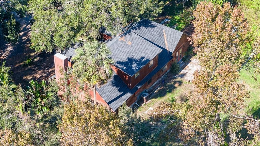 2641 McIntosh Road Dover, FL 33527 - Photo 51 of 58 an aerial view of a house with a yard and trees all around
