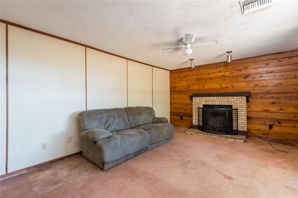 2641 McIntosh Road Dover, FL 33527 - Photo 6 of 58 a living room with furniture and a fireplace