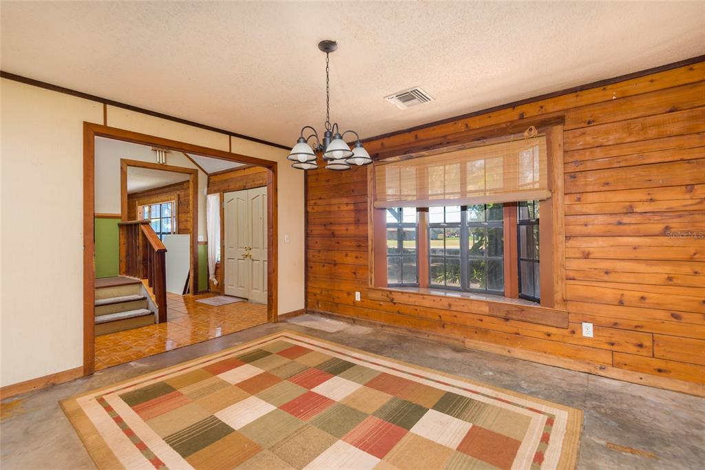 2641 McIntosh Road Dover, FL 33527 - Photo 9 of 58 a view of a room with wooden floor and stairs