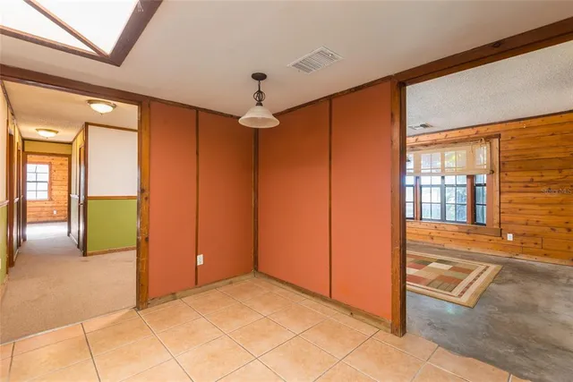 a dining room with stainless steel appliances granite countertop a sink and a refrigerator