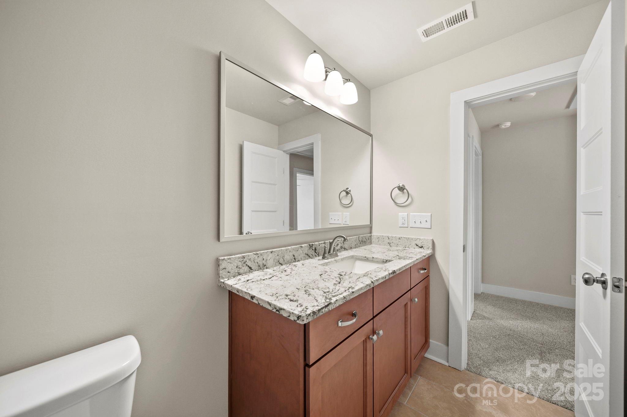 2601 Plyler Mill Road Monroe, NC 28112 - Photo 15 of 23 a bathroom with a granite countertop sink and a mirror