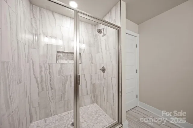 a bathroom with a granite countertop sink a toilet and shower