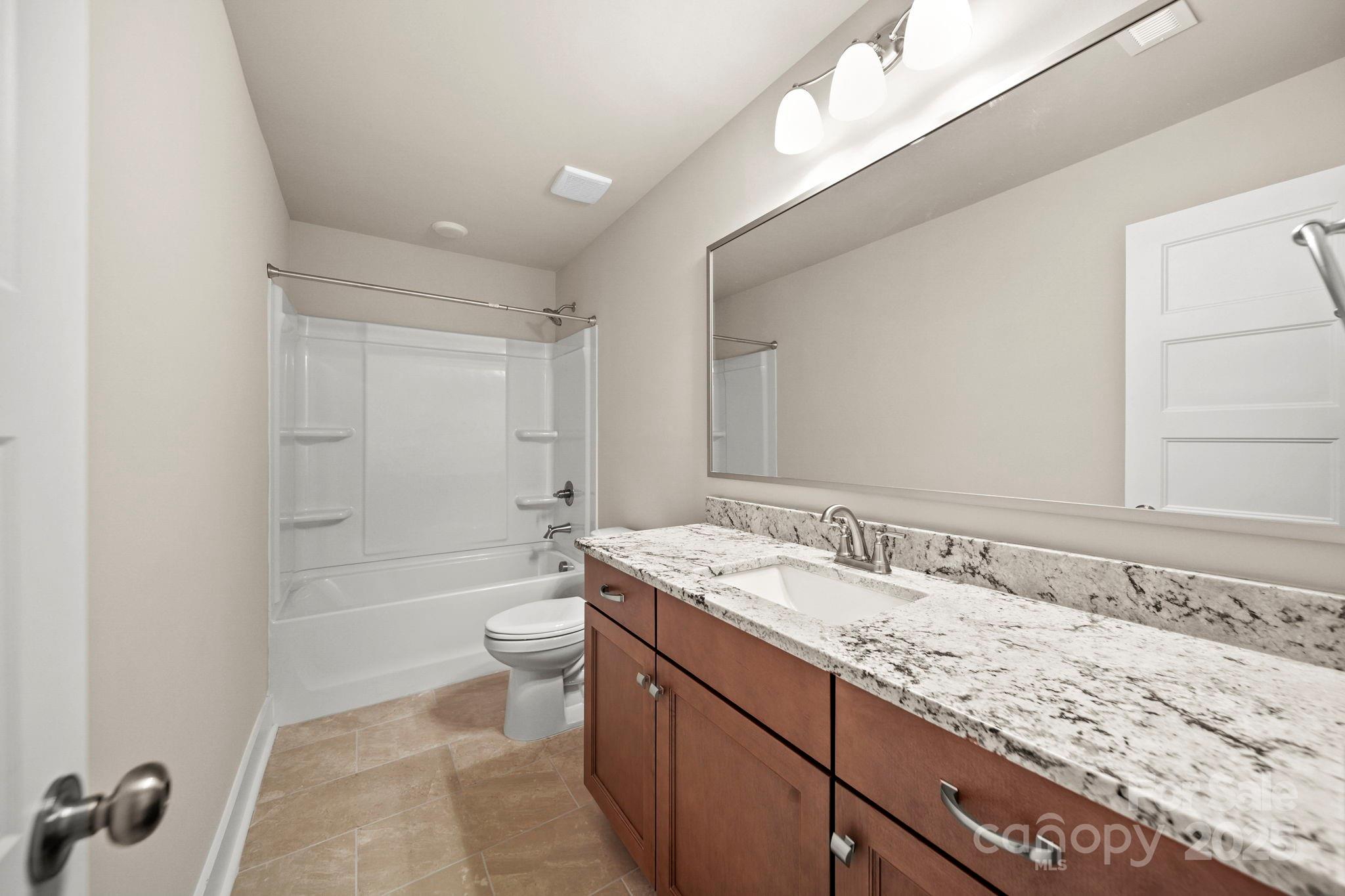 2601 Plyler Mill Road Monroe, NC 28112 - Photo 21 of 23 a bathroom with a granite countertop sink a toilet and shower