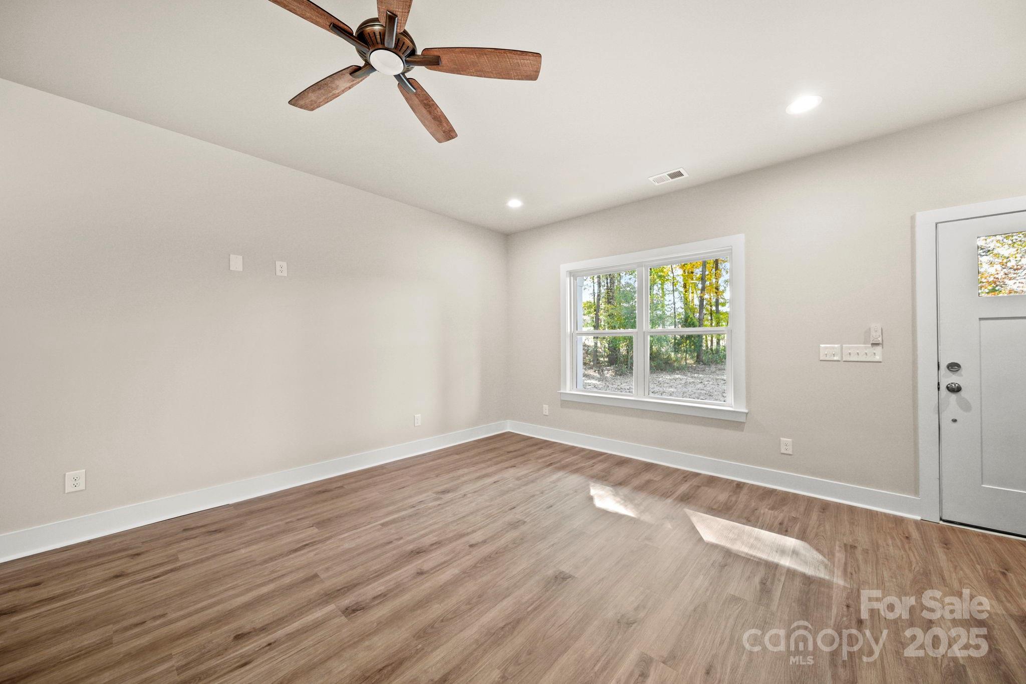 2601 Plyler Mill Road Monroe, NC 28112 - Photo 8 of 23 wooden floor in an empty room with a window