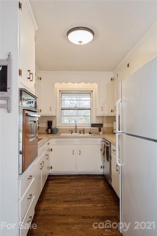 632 Scaleybark Road Charlotte, NC 28209 - Photo 21 of 36 a kitchen with white cabinets and white appliances