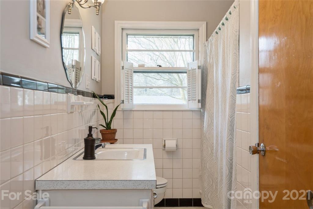 632 Scaleybark Road Charlotte, NC 28209 - Photo 25 of 36 a bathroom with a sink and a window