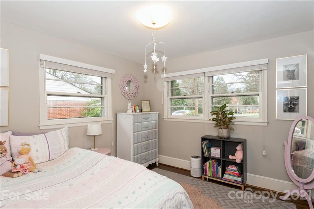 632 Scaleybark Road Charlotte, NC 28209 - Photo 29 of 36 a bedroom with a bed a chandelier and a window