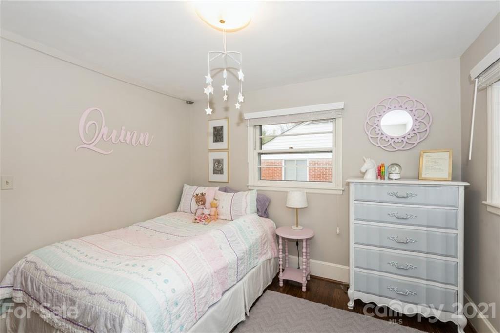 632 Scaleybark Road Charlotte, NC 28209 - Photo 30 of 36 a bedroom with a bed and a chandelier