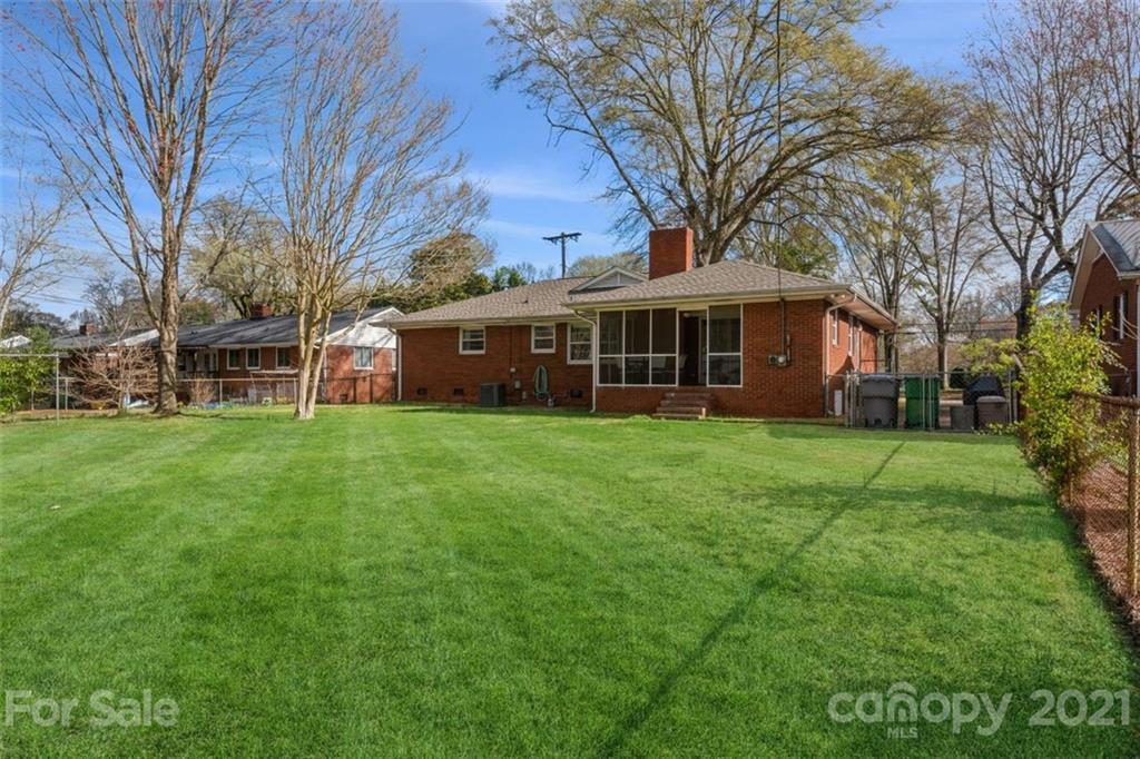 632 Scaleybark Road Charlotte, NC 28209 - Photo 6 of 36 a view of a house with a big yard and large trees