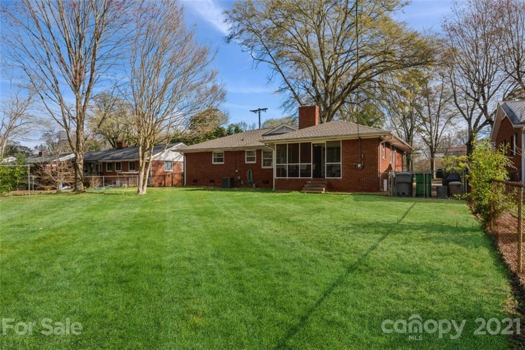 632 Scaleybark Road Charlotte, NC 28209 - Photo 7 of 36 a view of a house with a big yard and large trees