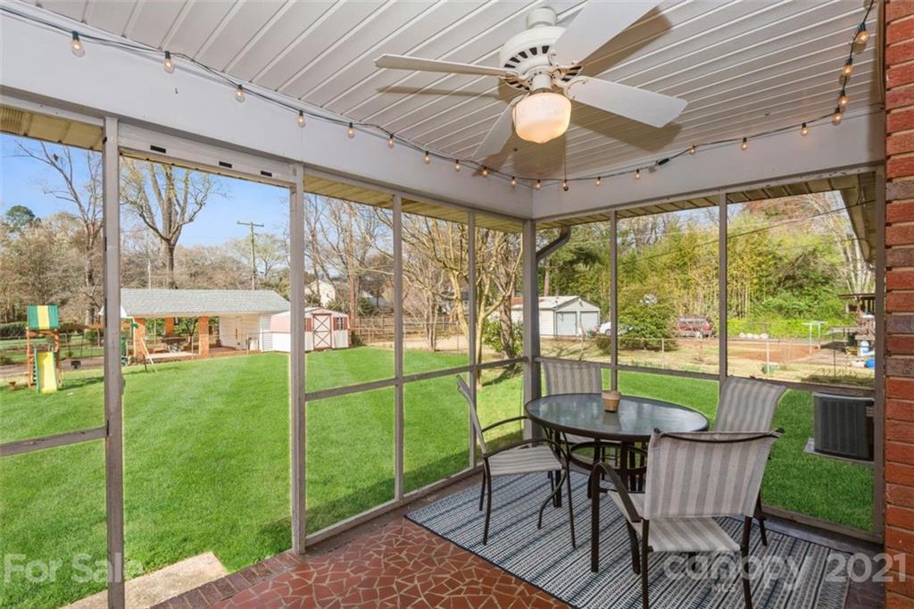 632 Scaleybark Road Charlotte, NC 28209 - Photo 8 of 36 a view of a dining room with furniture large windows and wooden floor