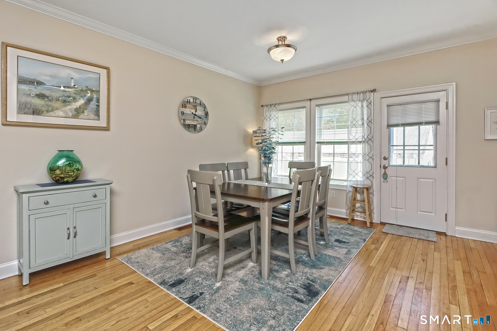 102 Lantern Court, Unit 102 Clinton, CT 06413 - Photo 13 of 36 a view of a dining room with furniture window and wooden floor