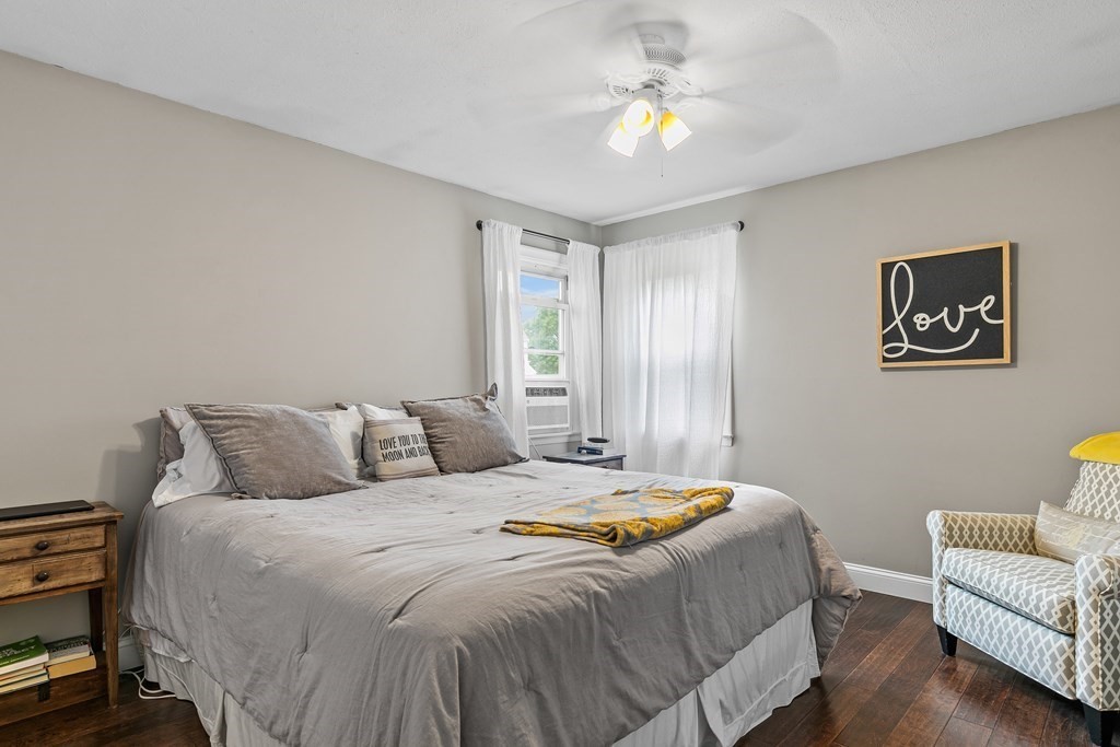 292 Cushman Road Rochester, MA 02770 - Photo 15 of 24 a bedroom with a bed and a chandelier