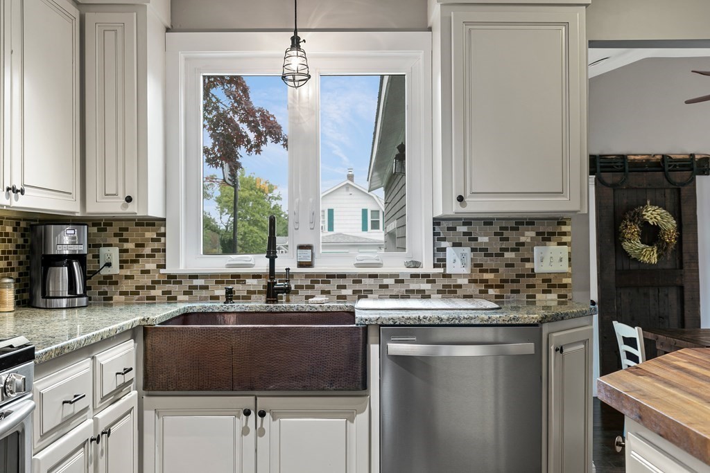 292 Cushman Road Rochester, MA 02770 - Photo 8 of 24 a kitchen with a sink stove and cabinets