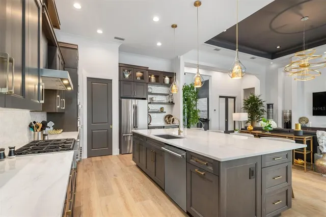 a kitchen with a sink and chairs