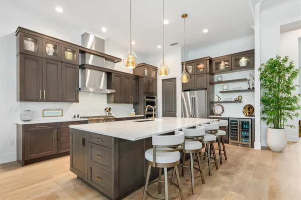 a dining room with furniture a chandelier and wooden floor