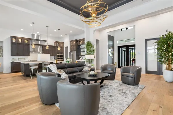 a living room with furniture and a chandelier