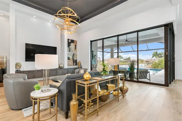 a living room with furniture and a floor to ceiling window
