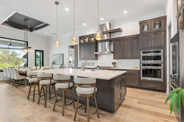 a large kitchen with a table and chairs