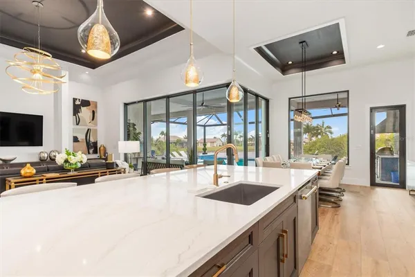a kitchen with stainless steel appliances granite countertop a sink and a refrigerator