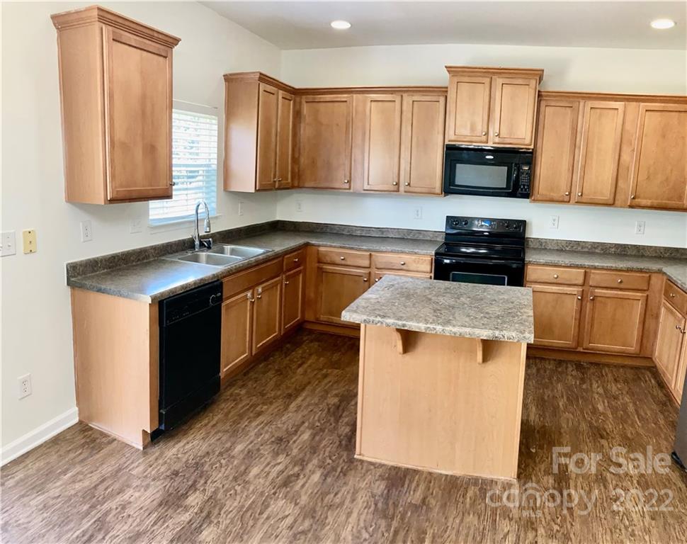 6432 Hermsley Road Charlotte, NC 28278 - Photo 13 of 32 a kitchen with stainless steel appliances granite countertop a stove a sink and a microwave