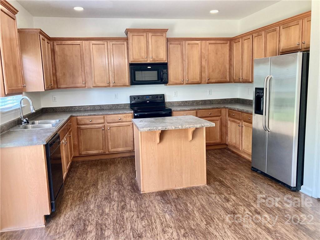 6432 Hermsley Road Charlotte, NC 28278 - Photo 14 of 32 a kitchen with stainless steel appliances granite countertop a stove a sink dishwasher and a refrigerator