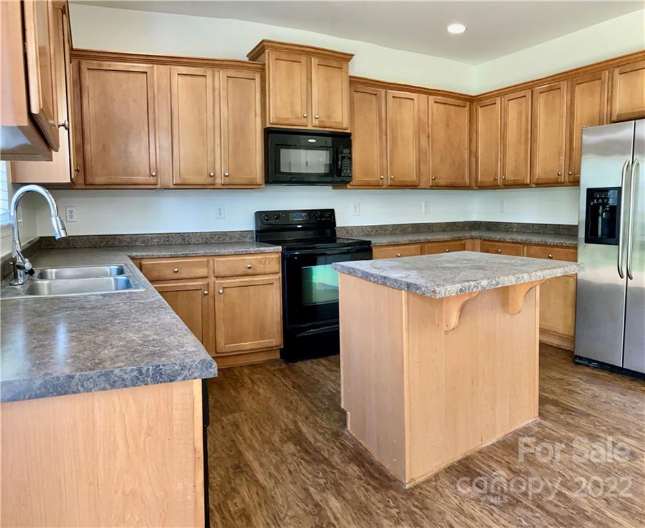 6432 Hermsley Road Charlotte, NC 28278 - Photo 15 of 32 a kitchen with stainless steel appliances granite countertop a stove a sink and a microwave
