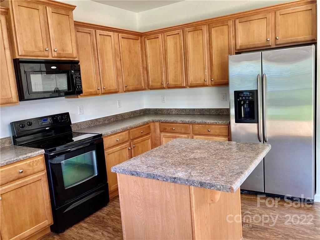 6432 Hermsley Road Charlotte, NC 28278 - Photo 16 of 32 a kitchen with stainless steel appliances granite countertop a refrigerator stove top oven and sink