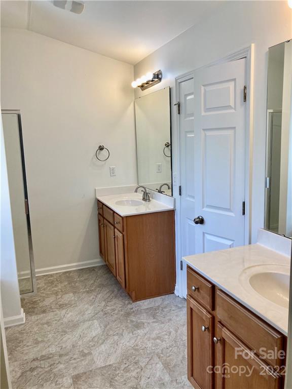 6432 Hermsley Road Charlotte, NC 28278 - Photo 29 of 32 a bathroom with a sink a mirror and a shower