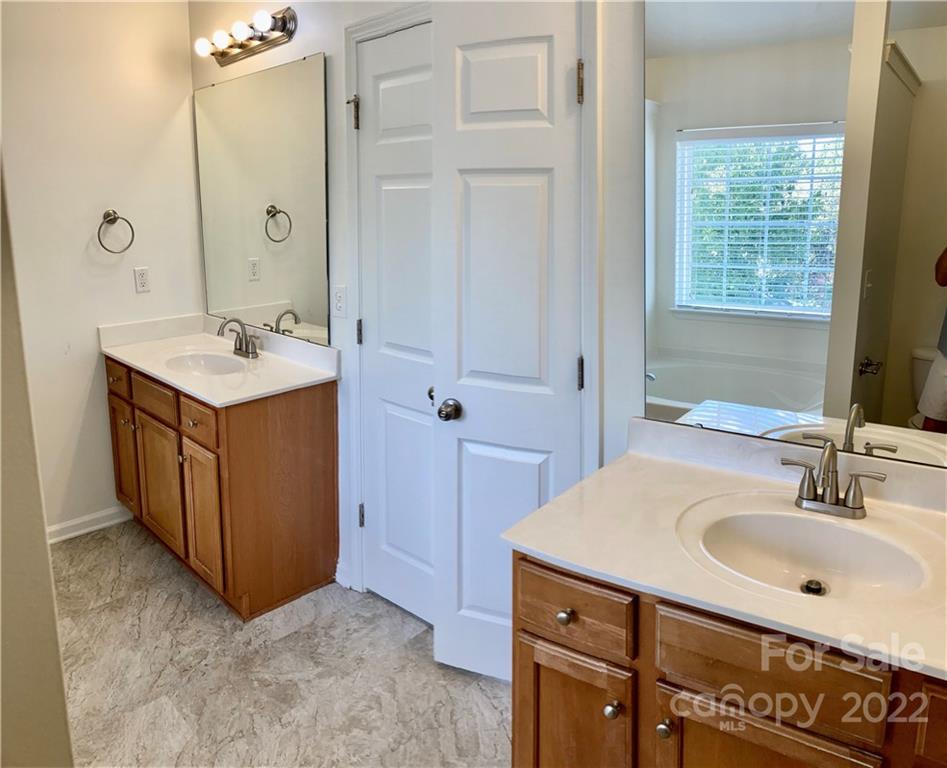 6432 Hermsley Road Charlotte, NC 28278 - Photo 30 of 32 a bathroom with a sink a mirror and a shower